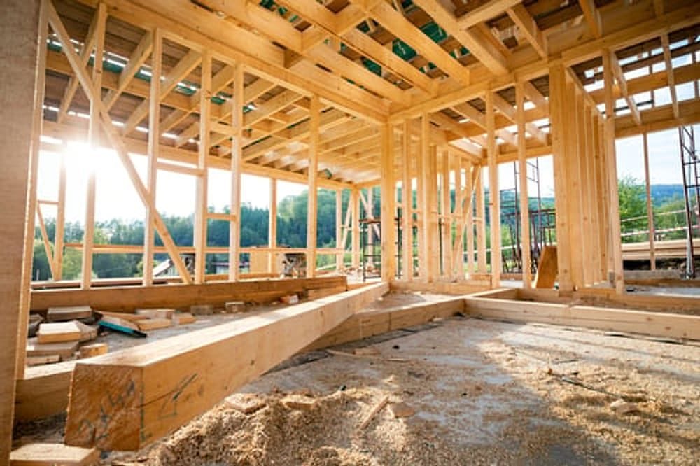 Wood structural framing and roof trusses on a new-build home framed by G&I B Construction